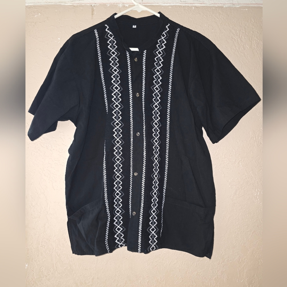 Guayabera shirt with white embroidery.